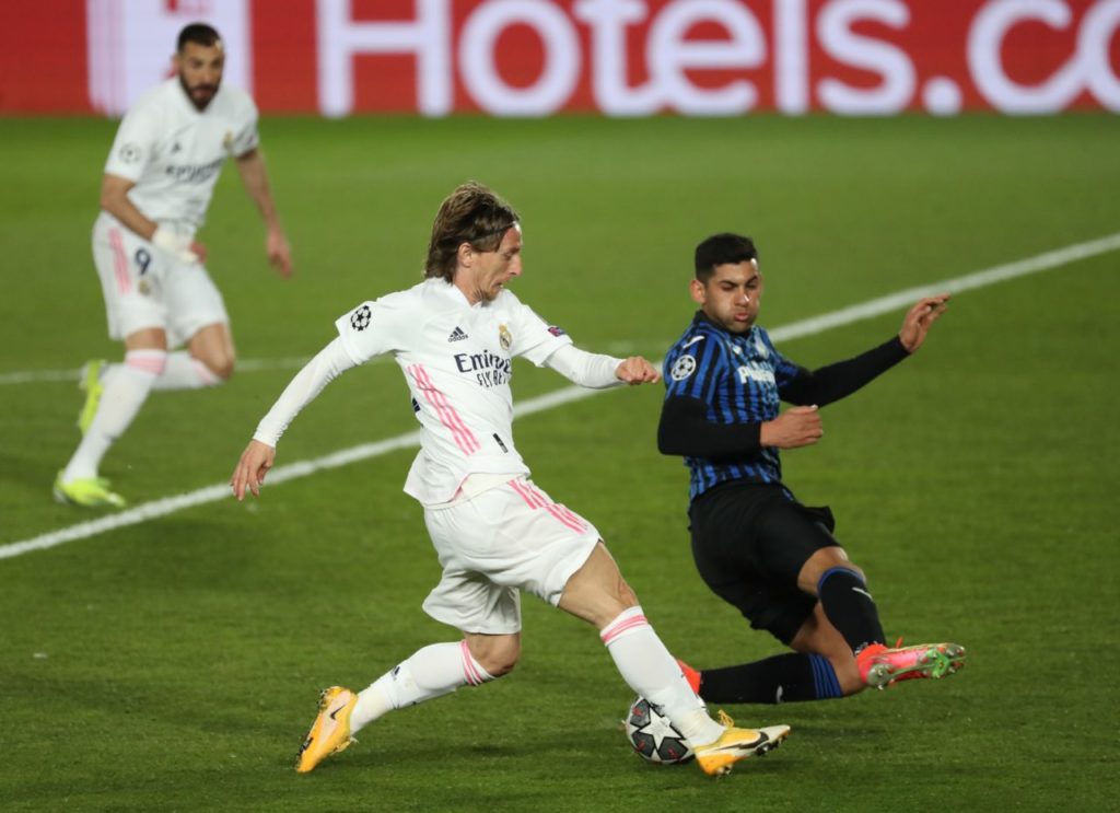 Atalanta defender Cristian Romero tackles Real Madrid's Luka Modric