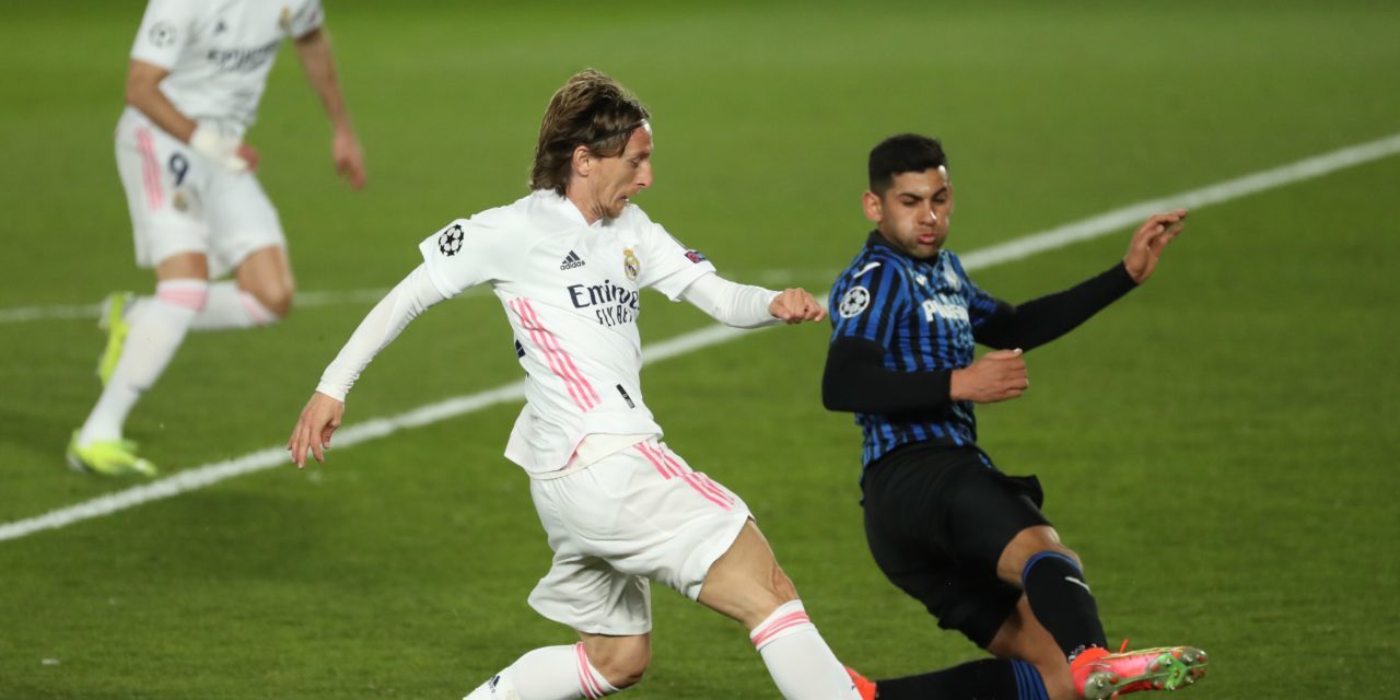 Atalanta defender Cristian Romero tackles Real Madrid's Luka Modric