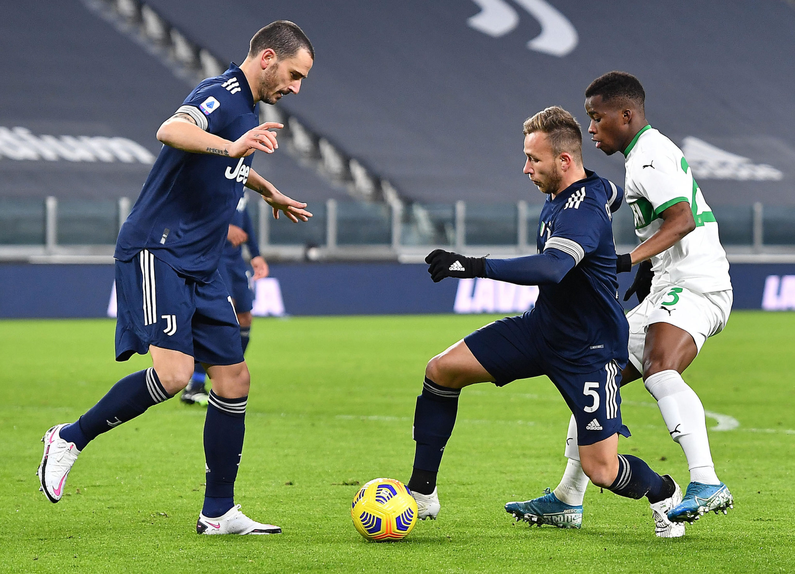 Juventus midfielder Arthur in action with Leonardo Bonucci