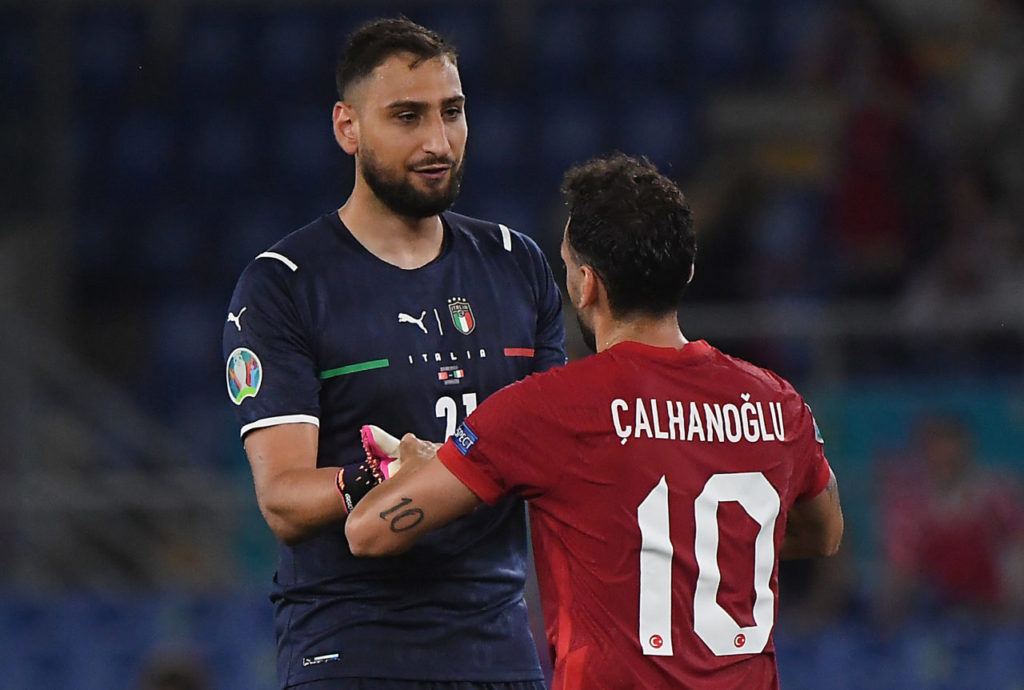 Gianluigi Donnarumma (L) of Italy and Hakan Calhanoglu of Turkey react after the UEFA EURO 2020 group A clash between Italy and Turkey