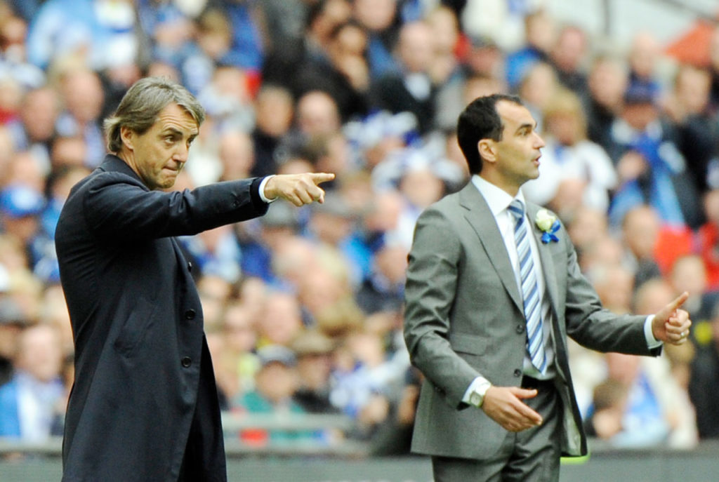 Wigan Athletic's Manager Roberto Martinez (R) and Manchester City Manager Roberto Mancini (L) give instructions to their players during the English FA Cup Final.