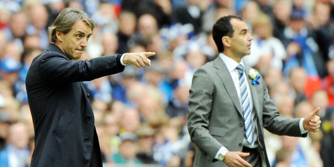 Wigan Athletic's Manager Roberto Martinez (R) and Manchester City Manager Roberto Mancini (L) give instructions to their players during the English FA Cup Final.