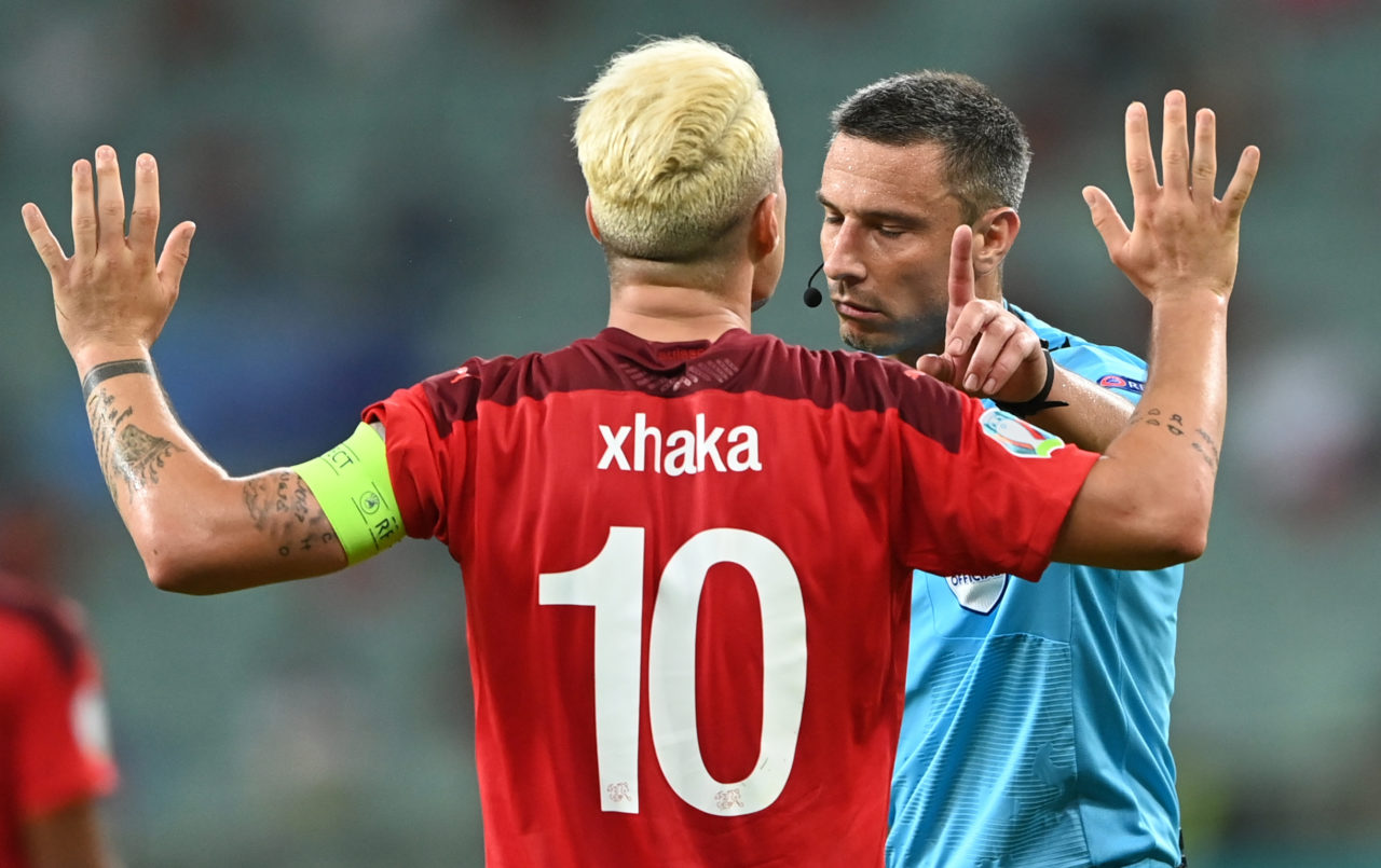Granit Xhaka of Switzerland and Slovenian referee Slavko Vincic