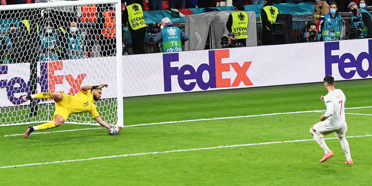 Alvaro Morato of Spain fails to convert his penalty against goalkeeper Gianluigi Donnarumma of Italy during the penalty shoot-out of the UEFA EURO 2020 semi final between Italy and Spain in London