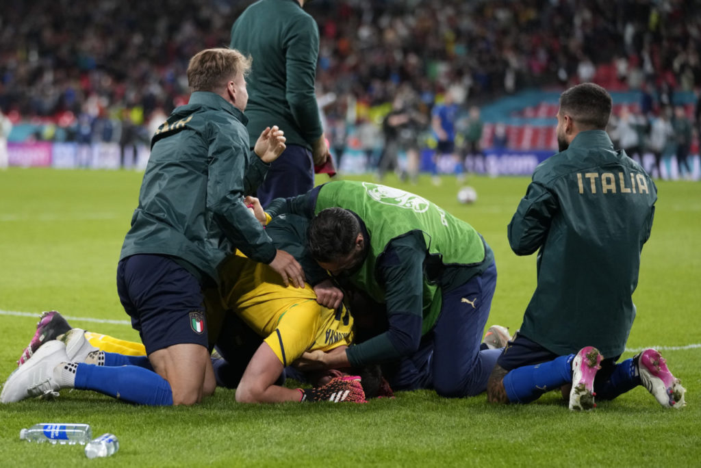 Players of Italy celebrate with goalkeeper Gianluigi Donnarumma (bottom) of Italy after the UEFA EURO 2020 semi final between Italy and Spain in London