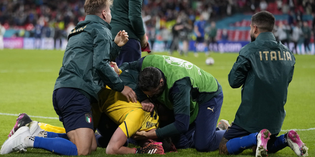 Players of Italy celebrate with goalkeeper Gianluigi Donnarumma (bottom) of Italy after the UEFA EURO 2020 semi final between Italy and Spain in London