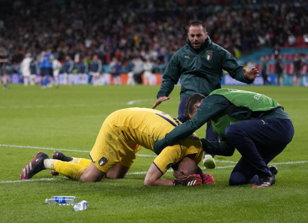Gianluigi Donnarumma (L) of Italy reacts after the UEFA EURO 2020 semi final between Italy and Spain in London