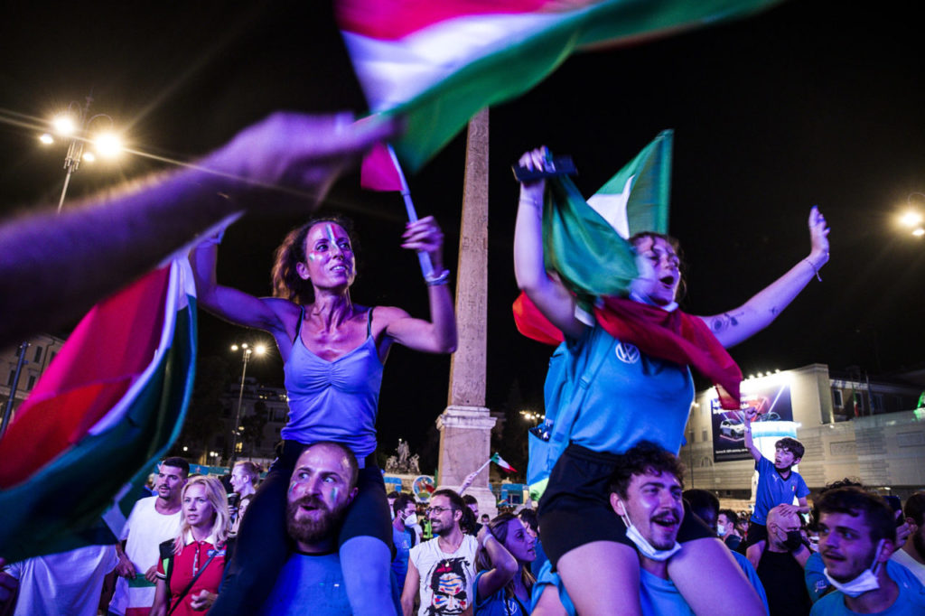 Italy fans cheer on their team as they watch the UEFA EURO 2020 semi final match between Italy and Spain at a public viewing in Piazza del Popolo, Rome