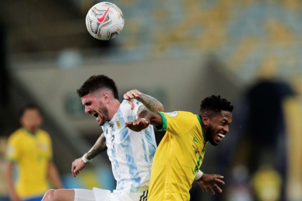 Rodrigo de Paul (L) fights for the ball with Fred from Brazil during the Copa America 2021 final between Argentina and Brazil at the Maracana Stadium in Rio de Janeiro.