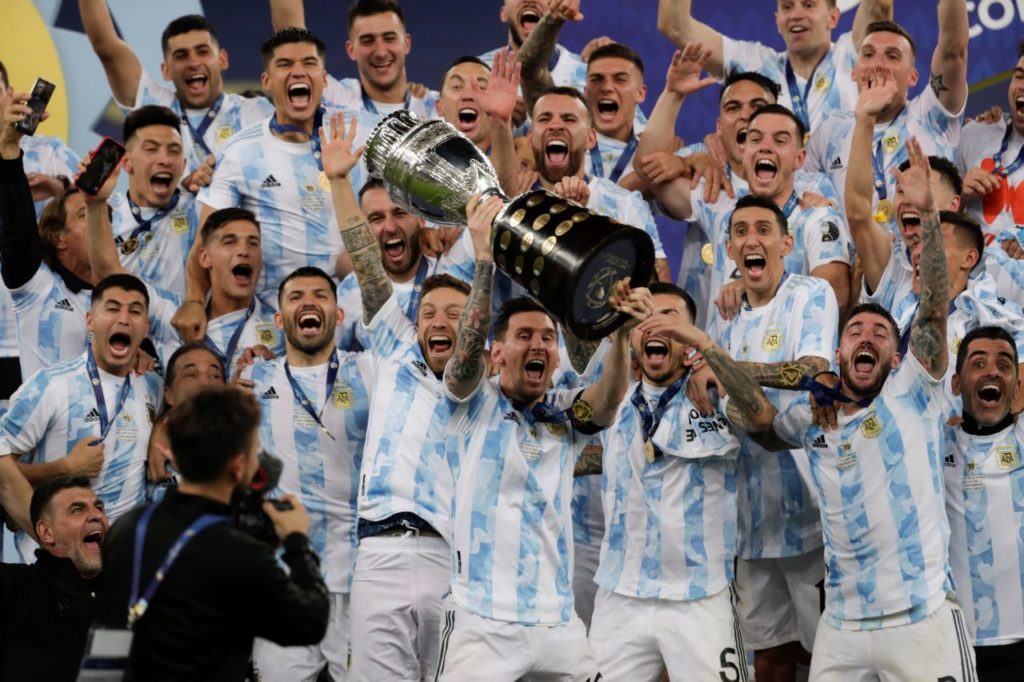 Argentina's Lionel Messi (C) celebrates with the Copa America trophy after the Copa America 2021 final between Argentina and Brazil at the Maracana Stadium in Rio de Janeiro, Brazil