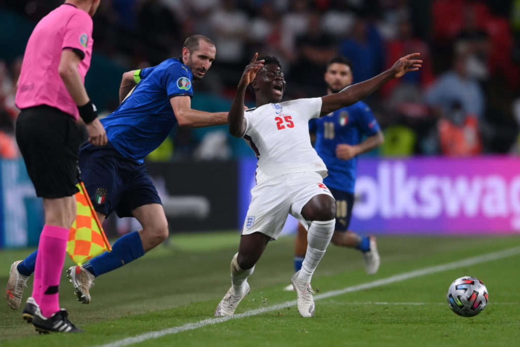 Giorgio Chiellini of Italy (L) fouls Bukayo Saka of England during the UEFA EURO 2020 final between Italy and England in London, Britain, 11 July 2021.