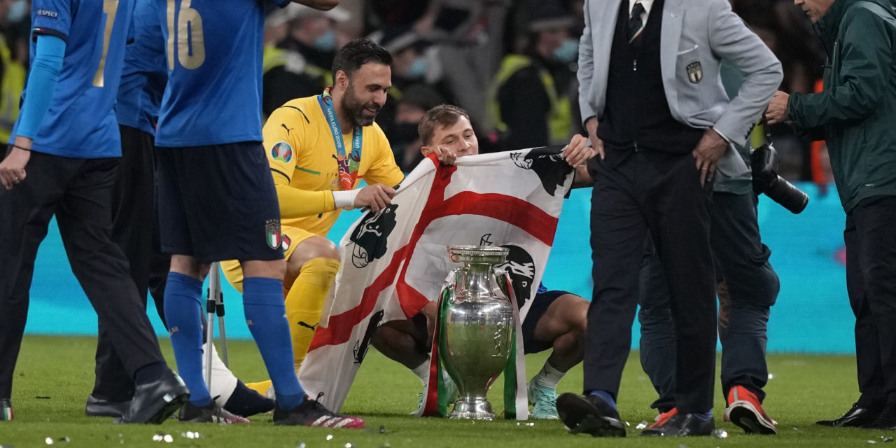 Salvatore Sirigu of Italy (C-L) and Nicolo Barella (C-R) of Italy celebrate with the trophy and a flag of Sardinia after the UEFA EURO 2020 final between Italy and England in London.