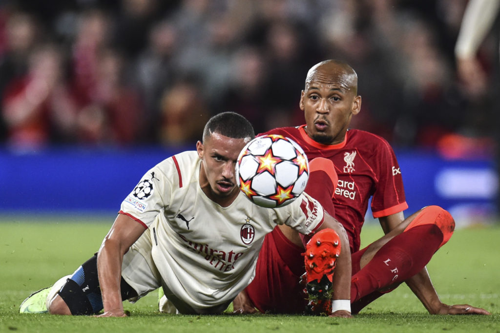 epa09470467 Ismael Bennacer (L) of AC Milan and Fabinho (R) of Liverpool FC in action during the UEFA Champions League group B soccer match between Liverpool FC and AC Milan in Liverpool, Britain, 15 September 2021. EPA-EFE/Peter Powell