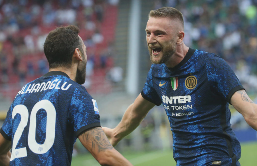 epa09423528 Inter Milan?s Milan Skriniar (R) celebrates with his teammate Hakan Calhanoglu after scoring the opening goal during the Italian Serie A soccer match between FC Inter and Genoa in Milan, Italy, 21 August 2021. EPA-EFE/MATTEO BAZZI