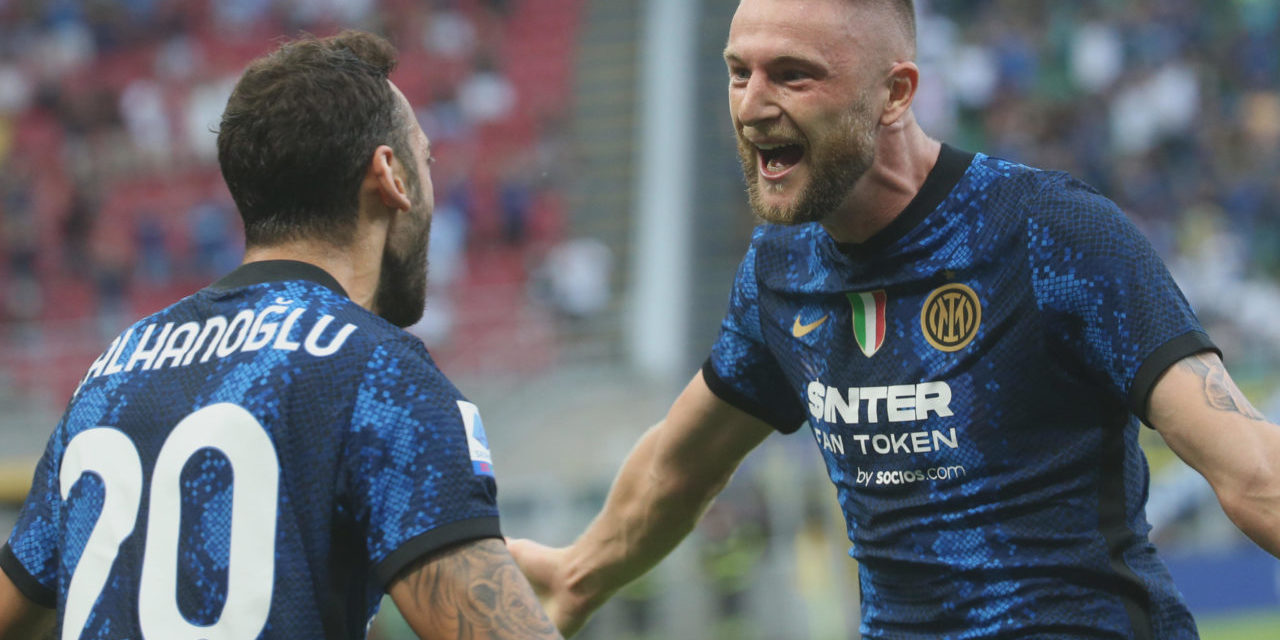 epa09423528 Inter Milan?s Milan Skriniar (R) celebrates with his teammate Hakan Calhanoglu after scoring the opening goal during the Italian Serie A soccer match between FC Inter and Genoa in Milan, Italy, 21 August 2021. EPA-EFE/MATTEO BAZZI