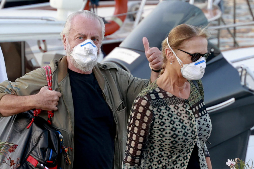 epa08659710 Napoli president Aurelio De Laurentiis (L), accompanied by his wife Jacqueline De Laurentiis, upon his arrival at the Luise pier on the Naples seafront, Naples, Italy, 10 September 2020. On 10 September 2020 Napoli announced that president Aurelio De Laurentiis tested positive for COVID-19 coronavirus. On 09 September 2020 De Laurentiis attended a meeting with officials from the 20 Italian Serie A clubs. EPA-EFE/CIRO FUSCO