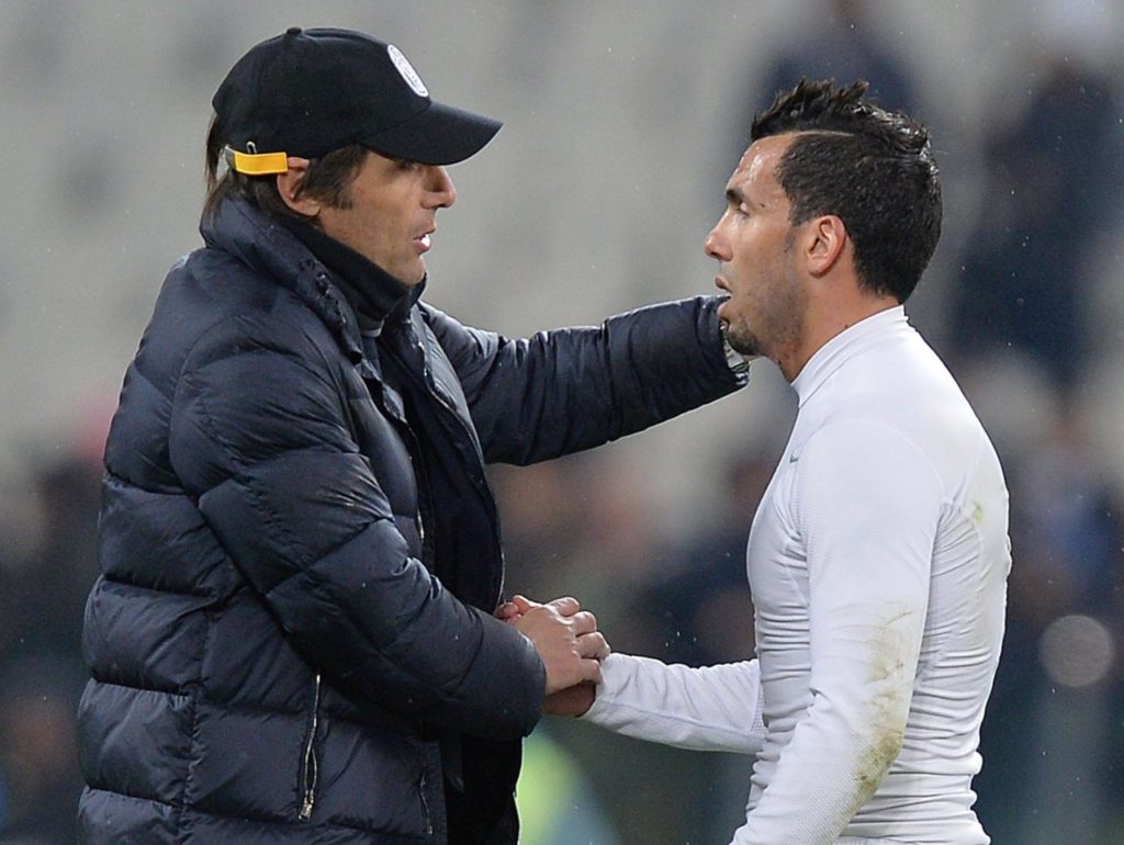 epa04142345 Italian head coach of Fc Juventus Antonio Conte (L) embraces his forward Carlos Tevez during the Italian Serie A soccer match between Juventus and Parma at the Juventus stadium in Turin, Italy, 26 March 2014. EPA/DI MARCO