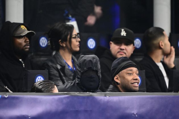 US rapper Kanye West (C) and girlfriend Bianca Censori are seen in the stands during the UEFA Champions League last 16 first leg football match Inter Milan vs Atletico Madrid at the San Siro stadium in Milan on February 20, 2024. (Photo by Marco BERTORELLO / AFP) (Photo by MARCO BERTORELLO/AFP via Getty Images)