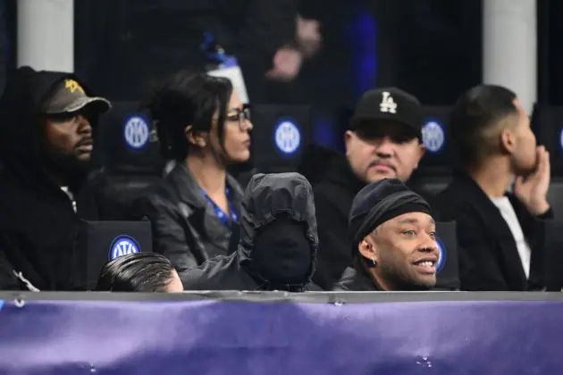 US rapper Kanye West (C) and girlfriend Bianca Censori are seen in the stands during the UEFA Champions League last 16 first leg football match Inter Milan vs Atletico Madrid at the San Siro stadium in Milan on February 20, 2024. (Photo by Marco BERTORELLO / AFP) (Photo by MARCO BERTORELLO/AFP via Getty Images)