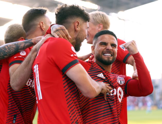 TORONTO, ON - JULY 23: Jonathan Osorio #21 of Toronto FC celebrates a goal with Lorenzo Insigne (R) #24 and teammates in an MLS game against Charlotte FC at BMO Field on July 23, 2022 in Toronto, Ontario, Canada. (Photo by Vaughn Ridley/Getty Images)