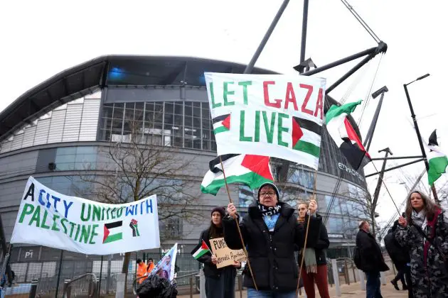 MANCHESTER, ENGLAND - FEBRUARY 17: Fans hold a sign in protest reading 'A City United With Palestine' and 'Let Gaza Live' outside the stadium prior to the Premier League match between Manchester City and Chelsea FC at Etihad Stadium on February 17, 2024 in Manchester, England. (Photo by Catherine Ivill/Getty Images)