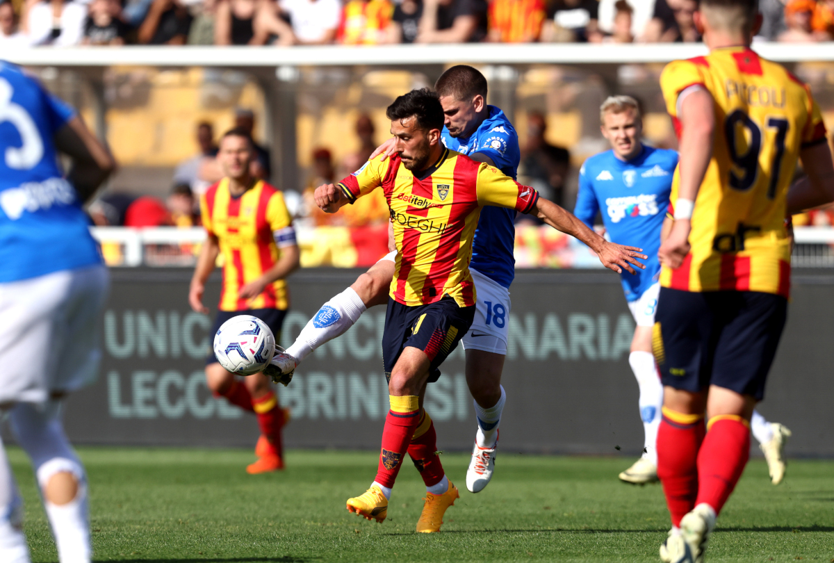 LECCE, ITALY - APRIL 13: Nicola Sansone of Lecce competes for the ball with Razvan Marin of Empoli during the Serie A TIM match between US Lecce and Empoli FC at Stadio Via del Mare on April 13, 2024 in Lecce, Italy. (Photo by Maurizio Lagana/Getty Images) (Serie A line-ups)