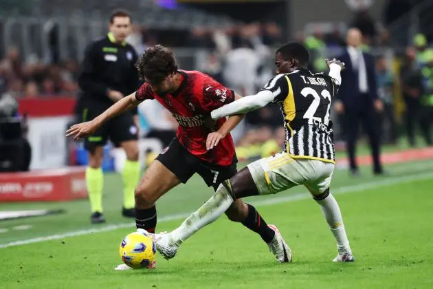 MILAN, ITALY - OCTOBER 22: Yacine Adli of AC Milan battles for possession with Timothy Weah of Juventus during the Serie A TIM match between AC Milan and Juventus at Stadio Giuseppe Meazza on October 22, 2023 in Milan, Italy. (Photo by Marco Luzzani/Getty Images)