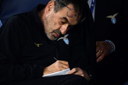 Lazio head coach Maurizio Sarri writes notes before the UEFA Champions League last 16 first leg between Lazio and Bayern Munich at the Olympic stadium on February 14, 2024 in Rome. (Photo by Filippo MONTEFORTE / AFP) (Photo by FILIPPO MONTEFORTE/AFP via Getty Images)