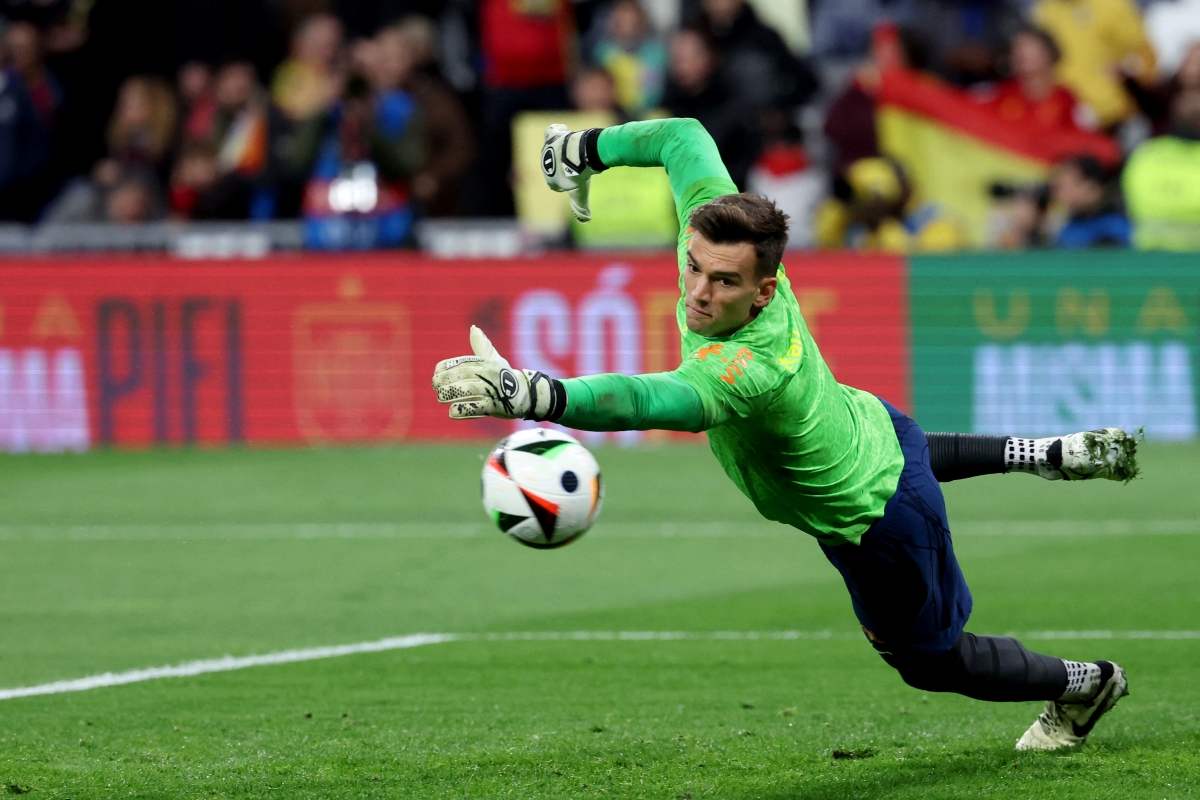 Brazil goalkeeper #01 Bento jumps for the ball as he warms up prior to the international friendly football match between Spain and Brazil at the Santiago Bernabeu stadium in Madrid, on March 26, 2024. Spain arranged a friendly against Brazil at the Santiago Bernabeu under the slogan