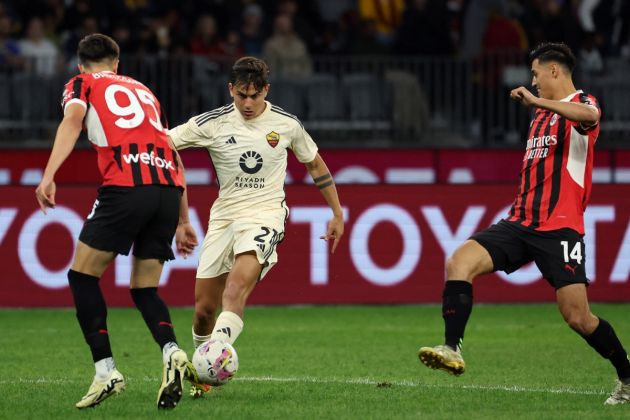 AS Roma forward Paulo Dybala takes control of the ball from AC Milan duo Tijjani Reijnders (R) and Davide Bartesaghi (L) during a friendly match between AC Milan and AS Roma at the Perth Rectangular Stadium in Perth on May 31, 2024. (Photo by COLIN MURTY / AFP) / -- IMAGE RESTRICTED TO EDITORIAL USE - STRICTLY NO COMMERCIAL USE -- (Photo by COLIN MURTY/AFP via Getty Images)