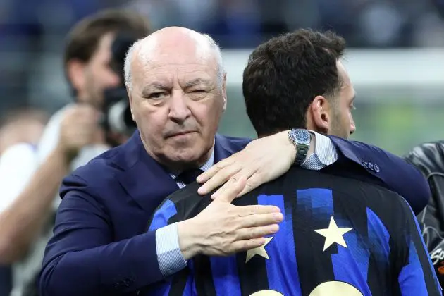 MILAN, ITALY - MAY 19: Giuseppe Marotta, CEO of FC Internazionale, embraces Hakan Calhanoglu of FC Internazionale during the Serie A TIM Scudetto title trophy presentation at full-time following the team's draw in the Serie A TIM match between FC Internazionale and SS Lazio at Stadio Giuseppe Meazza on May 19, 2024 in Milan, Italy. (Photo by Marco Luzzani/Getty Images)