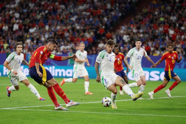 GELSENKIRCHEN, GERMANY - JUNE 20: Alvaro Morata of Spain shoots whilst under pressure from Giovanni Di Lorenzo of Italy during the UEFA EURO 2024 group stage match between Spain and Italy at Arena AufSchalke on June 20, 2024 in Gelsenkirchen, Germany. (Photo by Lars Baron/Getty Images)