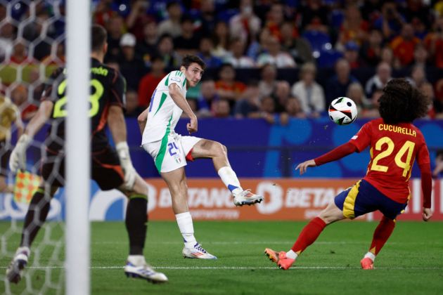 Italy's defender #24 Andrea Cambiaso (C) kicks the ball next to Spain's defender #24 Marc Cucurella (R) and Spain's goalkeeper #23 Unai Simon during the UEFA Euro 2024 Group B football match between Spain and Italy at the Arena AufSchalke in Gelsenkirchen on June 20, 2024. (Photo by KENZO TRIBOUILLARD / AFP) (Photo by KENZO TRIBOUILLARD/AFP via Getty Images)