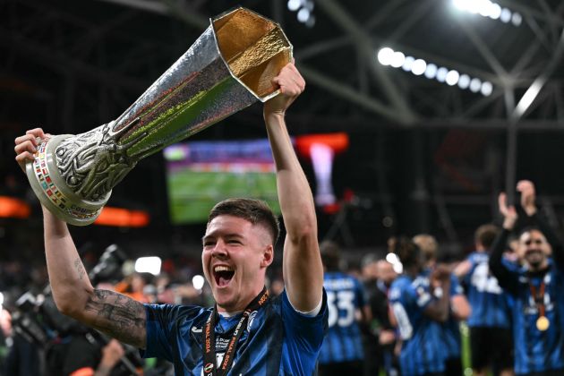 Atalanta defender and Juventus linked #03 Emil Holm holds the trophy as Atalanta's players celebrate after the UEFA Europa League final football match between Atalanta and Bayer Leverkusen at the Dublin Arena stadium, in Dublin, on May 22, 2024. Atalanta won the game 3-0. (Photo by Paul ELLIS / AFP) (Photo by PAUL ELLIS/AFP via Getty Images)