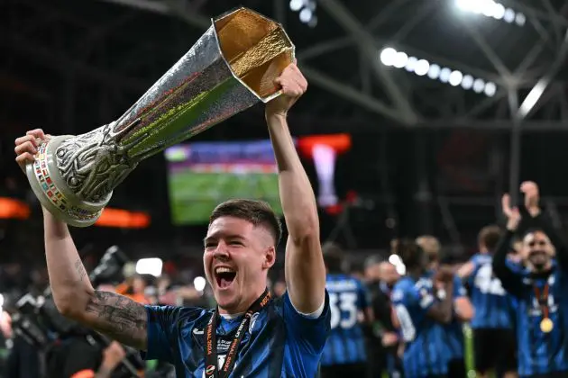 Atalanta defender and Juventus linked #03 Emil Holm holds the trophy as Atalanta's players celebrate after the UEFA Europa League final football match between Atalanta and Bayer Leverkusen at the Dublin Arena stadium, in Dublin, on May 22, 2024. Atalanta won the game 3-0. (Photo by Paul ELLIS / AFP) (Photo by PAUL ELLIS/AFP via Getty Images)