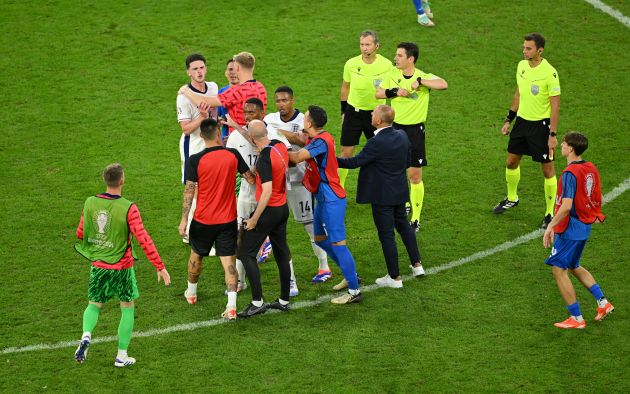 GELSENKIRCHEN, GERMANY - JUNE 30: Declan Rice of England clashes with Francesco Calzona, Head Coach of Slovakia, as he is held back by teammates after the UEFA EURO 2024 round of 16 match between England and Slovakia at Arena AufSchalke on June 30, 2024 in Gelsenkirchen, Germany. (Photo by Shaun Botterill/Getty Images)