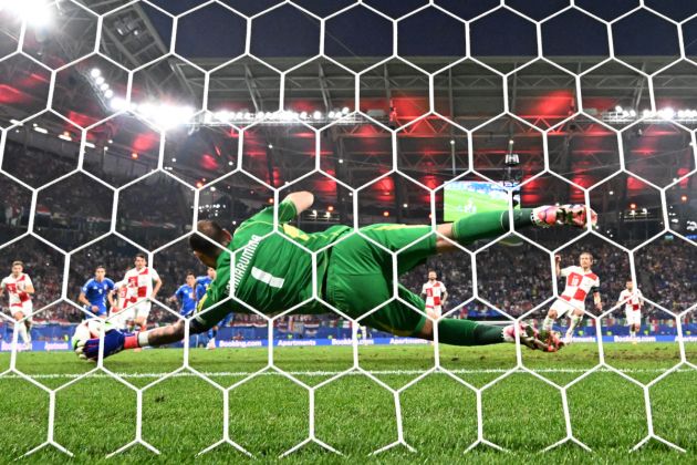 TOPSHOT - Italy's goalkeeper #01 Gianluigi Donnarumma saves a penalty taken by Croatia's midfielder #10 Luka Modric (R) during the UEFA Euro 2024 Group B football match between the Croatia and Italy at the Leipzig Stadium in Leipzig on June 24, 2024. (Photo by Christophe Simon / AFP) (Photo by CHRISTOPHE SIMON/AFP via Getty Images)