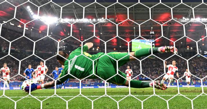 TOPSHOT - Italy's goalkeeper #01 Gianluigi Donnarumma saves a penalty taken by Croatia's midfielder #10 Luka Modric (R) during the UEFA Euro 2024 Group B football match between the Croatia and Italy at the Leipzig Stadium in Leipzig on June 24, 2024. (Photo by Christophe Simon / AFP) (Photo by CHRISTOPHE SIMON/AFP via Getty Images)