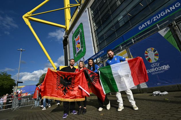 Italy and Albania's fans pose with their national flags prior the UEFA Euro 2024 Group B football match between Italy and Albania at the BVB Stadion in Dortmund, western Germany, on June 15, 2024. (Photo by OZAN KOSE / AFP) (Photo by OZAN KOSE/AFP via Getty Images)