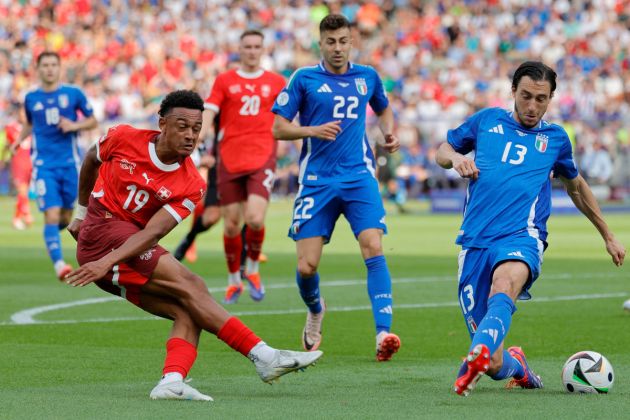 Italy's defender #13 Matteo Darmian blocks a shot by Switzerland's forward #19 Dan Ndoye during the UEFA Euro 2024 round of 16 football match between Switzerland and Italy at the Olympiastadion Berlin in Berlin on June 29, 2024. (Photo by AXEL HEIMKEN / AFP) (Photo by AXEL HEIMKEN/AFP via Getty Images)