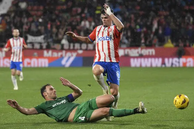 Osasuna's Spanish defender #04 Unai Garcia (L) tackles Girona's Spanish defender #03 Miguel Gutierrez during the Spanish league football match between Girona FC and CA Osasuna at the Montilivi stadium in Girona on March 9, 2024. (Photo by Josep LAGO / AFP) (Photo by JOSEP LAGO/AFP via Getty Images)