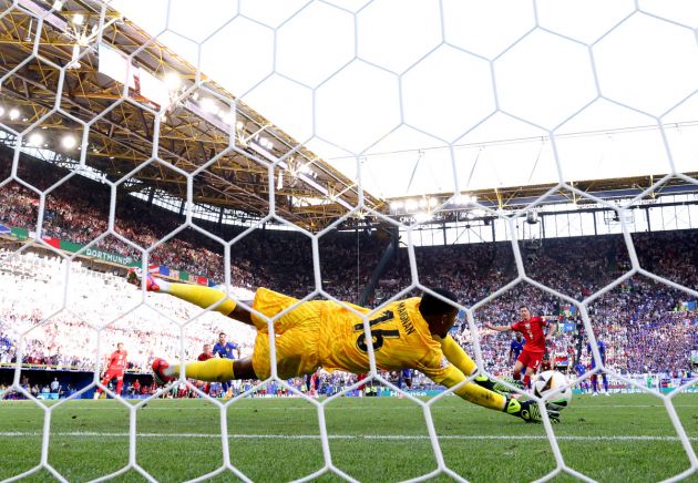 DORTMUND, GERMANY - JUNE 25: (EDITORS NOTE: Image was captured using a static remote camera behind the goal.) A general view as Mike Maignan of France saves a penalty kick from Robert Lewandowski of Poland, which is later retaken after a VAR Review concludes an encroachment ruling, during the UEFA EURO 2024 group stage match between France and Poland at Football Stadium Dortmund on June 25, 2024 in Dortmund, Germany. (Photo by Kevin C. Cox/Getty Images)