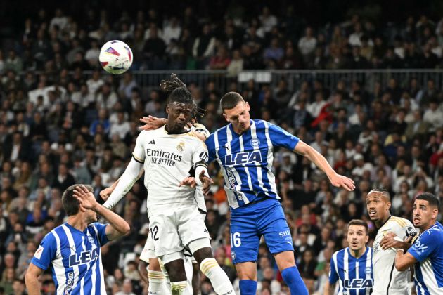 Real Madrid's French midfielder #12 Eduardo Camavinga and Alaves' Spanish defender #16 Rafa Marin head the ball during the Spanish league football match between Real Madrid CF and Deportivo Alaves at the Santiago Bernabeu stadium in Madrid on May 14, 2024. (Photo by JAVIER SORIANO / AFP) (Photo by JAVIER SORIANO/AFP via Getty Images)