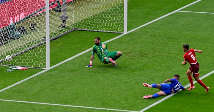 Switzerland's midfielder #08 Remo Freuler (R) kicks the ball to score his team's first goal against Italy's goalkeeper #01 Gianluigi Donnarumma (L) during the UEFA Euro 2024 round of 16 football match between Switzerland and Italy at the Olympiastadion Berlin in Berlin on June 29, 2024. (Photo by JOHN MACDOUGALL / AFP) (Photo by JOHN MACDOUGALL/AFP via Getty Images)