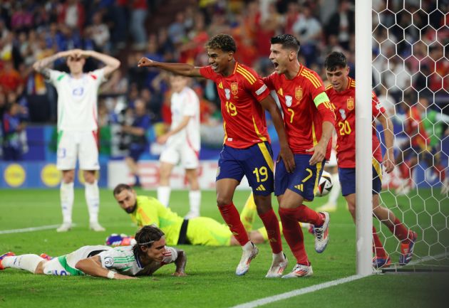 GELSENKIRCHEN, GERMANY - JUNE 20: Riccardo Calafiori of Italy looks dejected after scoring an own goal and the first goal for Spain as Lamine Yamal, Alvaro Morata and Pedri of Spain celebrate during the UEFA EURO 2024 group stage match between Spain and Italy at Arena AufSchalke on June 20, 2024 in Gelsenkirchen, Germany. (Photo by Kevin C. Cox/Getty Images)