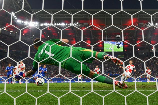 LEIPZIG, GERMANY - JUNE 24: (EDITORS NOTE: Image was captured using a static remote camera behind the goal.) Gianluigi Donnarumma of Italy dives to save the penalty of Luka Modric of Croatia during the UEFA EURO 2024 group stage match between Croatia and Italy at Football Stadium Leipzig on June 24, 2024 in Leipzig, Germany. (Photo by Dan Mullan/Getty Images)