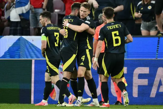 Scotland midfielder #04 Scott McTominay (C) celebrates with teammates after scoring his team's first goal during the UEFA Euro 2024 Group A football match between Scotland and Switzerland at the Cologne Stadium in Cologne on June 19, 2024. (Photo by Angelos Tzortzinis / AFP) (Photo by ANGELOS TZORTZINIS/AFP via Getty Images)