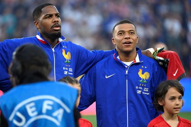 France forward #10 Kylian Mbappe (R) sings the national antheam ahead of the International friendly football match between France and Luxembourg at Saint-Symphorien Stadium in Longeville-les-Metz, eastern France, on June 5, 2024. (Photo by Jean-Christophe VERHAEGEN / AFP) (Photo by JEAN-CHRISTOPHE VERHAEGEN/AFP via Getty Images)