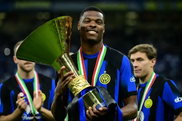 Inter Milan defender Denzel Dumfries poses with the trophy during the ceremony for the Italian Champions following the Italian Serie A football match between Inter Milan and Lazio in Milan, on May 19, 2024. Inter celebrates his 20th Scudetto. (Photo by Marco BERTORELLO / AFP) (Photo by MARCO BERTORELLO/AFP via Getty Images)