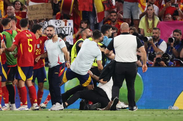 MUNICH, GERMANY - JULY 09: A Member of Security slides into Alvaro Morata of Spain as he attempts to remove a Pitch Invader as players of Spain celebrate after the UEFA EURO 2024 Semi-Final match between Spain and France at Munich Football Arena on July 09, 2024 in Munich, Germany. (Photo by Alex Grimm/Getty Images)